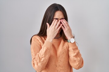 Sticker - Young brunette woman standing over white background rubbing eyes for fatigue and headache, sleepy and tired expression. vision problem