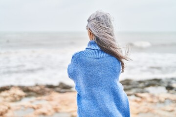 Canvas Print - Middle age grey-haired woman standing on back view at seaside