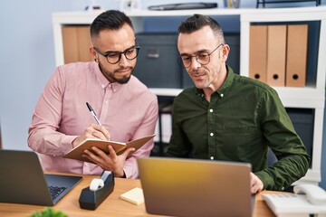 Sticker - Two men business workers using laptop writing on notebook at office