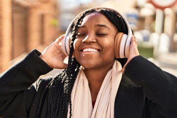 Poster - African american woman listening to music at street