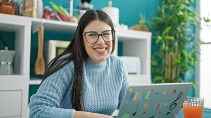 Sticker - Young hispanic woman using laptop at dinning room