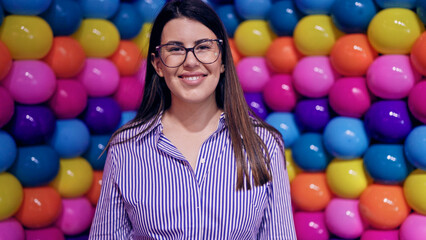 Wall Mural - Young beautiful hispanic woman visiting colorful futuristic exhibition space