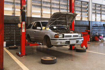 Wall Mural - car repair in garage service station with soft-focus and over light in the background