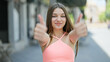 © Krakenimages.com - Young beautiful girl smiling confident doing ok sign with thumbs up at street