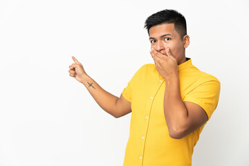 Young Ecuadorian man isolated on white background with surprise expression while pointing side