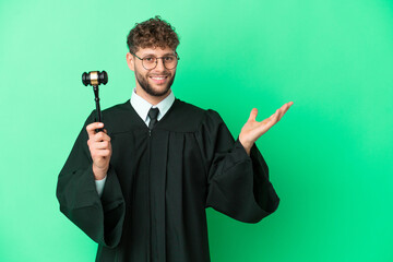 Canvas Print - Judge over isolated green background extending hands to the side for inviting to come