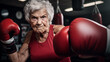 An old woman boxer on guard wearing a red tank top and boxe gloves in a combat gym.
