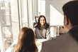 © Maria Vitkovska - Smiling woman talking, brainstorming, while working with group of confident businesspeople
