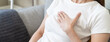 © Pormezz - woman suffering at chest from acid reflux disease