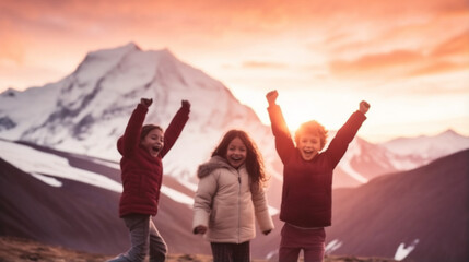 Wall Mural - Defocused image of three kids cheering and beeing happy in mountain landscape at sunset
