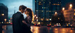© Andrea Raffin - A young elegant romantic couple hugged in a modern cityscape full of blurred lights.