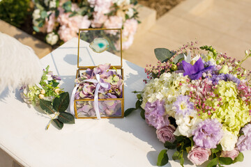 Wall Mural - Box with wedding rings for painting newlyweds, decorated with fresh flower petals. Wedding decoration concept