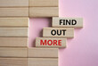Find out more symbol. Concept word Find out more on wooden blocks. Beautiful pink background. Business and Find out more concept. Copy space