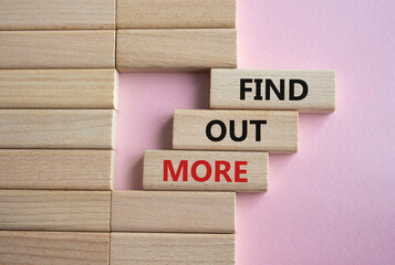 Find out more symbol. Concept word Find out more on wooden blocks. Beautiful pink background. Business and Find out more concept. Copy space