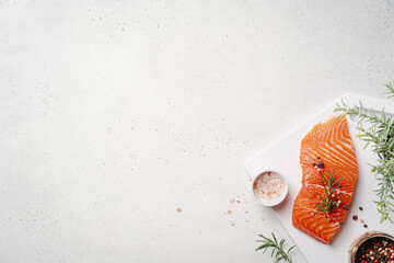 Wall Mural - Salmon. Fresh raw salmon fish fillet with cooking ingredients, herbs and lemon on white background, top view