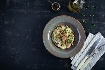 Wall Mural - Italian cuisine - risotto with mushrooms. Cooked arborio rice with parmesan cheese and mushrooms