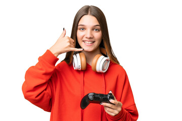 Sticker - Teenager caucasian girl playing with a video game controller over isolated background making phone gesture. Call me back sign