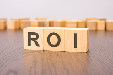 Wall Mural - ROI text on wooden blocks. wooden background. foreground