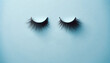 Blue monday concept. Closed eyes with black eyelashes on blue background. Melancholy and gloomy emotions