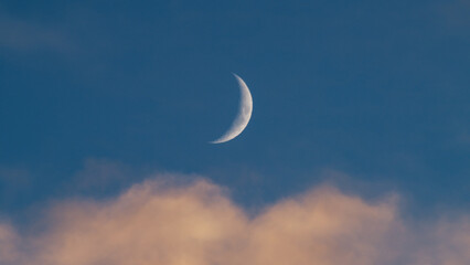 orange clouds with blue sky and moon in christmas sky