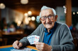 Happy senior man playing card games with friends, activity social networking in nurs home. Concept enjoying playtime together in poker game, old men