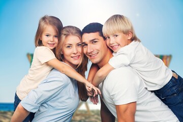 Sticker - Happy family. young parents and children walk on the beach.