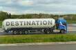 On a tank truck driving along the road there is an inscription - Destination