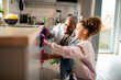 © Marko Geber - Father and daughter cleaning kitchen