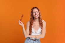 Stylish Young Hippie Woman With Sunglasses On Orange Background