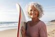 Middle-aged woman holding a surfboard on a beach