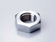 Metal nut on clean white background. Stainless steel hardware.