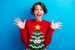 Photo of impressed excited lady santa helper dressed print sweater enjoying xmas surprises isolated blue color background