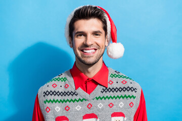 Sticker - Photo portrait of handsome young guy toothy beaming smile wear x-mas print vest hat outfit isolated on blue color background