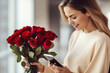 Woman on a cellphone is surprised with a bouquet gift of flowers