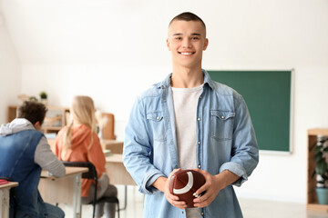 Poster - Male student with rugby ball in classroom