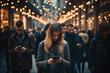 A crowd of people is walking by the street and checking their smartphones.