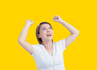 Young  excited  woman with success gesture isolated on yellow background