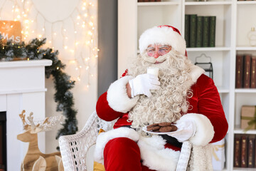 Wall Mural - Santa Claus drinking milk with cookies at home on Christmas eve