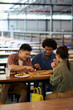 © DragonImages - Friends enjoying delicious pizza in outdoor cafe