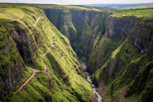 Breathtaking Aerial View Of Deep And Rugged Gorge, Showcasing Winding River, Steep Cliffs, And Sense Of Awe And Adventure When Looking Down Into This Natural Chasm