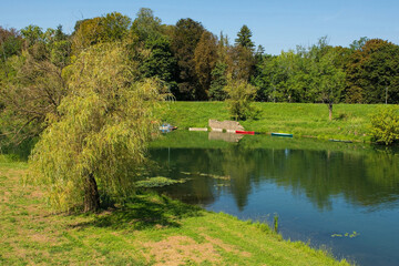 Wall Mural - Wooden boats on the Korana River as it passes through the town of Karlovac in central Croatia