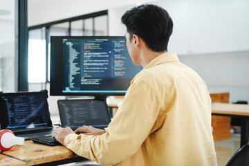 it programmer starts working on desktop computer.