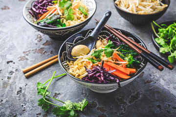 Wall Mural - Vegan miso noodle soup with mushrooms, red cabbage, carrots and sprouts