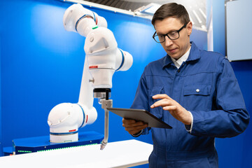 Leinwandbilder - Automatic welding robot in a modern factory in operation