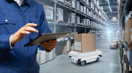 Poster - Warehouse manager with digital tablet controls robot with a package. Unmanned delivery concept.