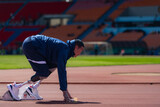 Fototapeta  - Disabled athletes prepare in starting position ready to run on stadium track