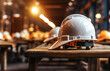 A hard hat sitting on top of a wooden table. Many hard hats on background.