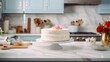 A white cake sitting on top of a kitchen counter