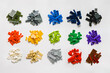 Pile of many various colored stackable plastic toy bricks isolated on white background. Top view