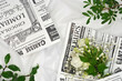 White flowers and retro newspaper on a light background, flat lay. 